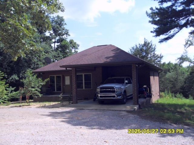 a front view of a house with a garden and parking space