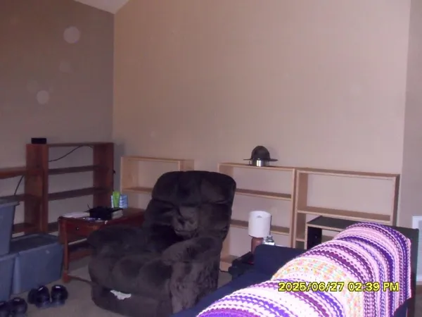 a living room with furniture lamp and window