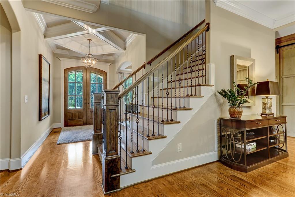 6865 Matzinger Court Oak Ridge, NC 27310 - Photo 1 of 28 This entry will impress! Over-sized double entry doors, hardwood flooring, central chandelier, and coffered ceiling detail. Ready for your move in - blinds throughout, gutter guards, fully landscaped back yard with irrigation system.