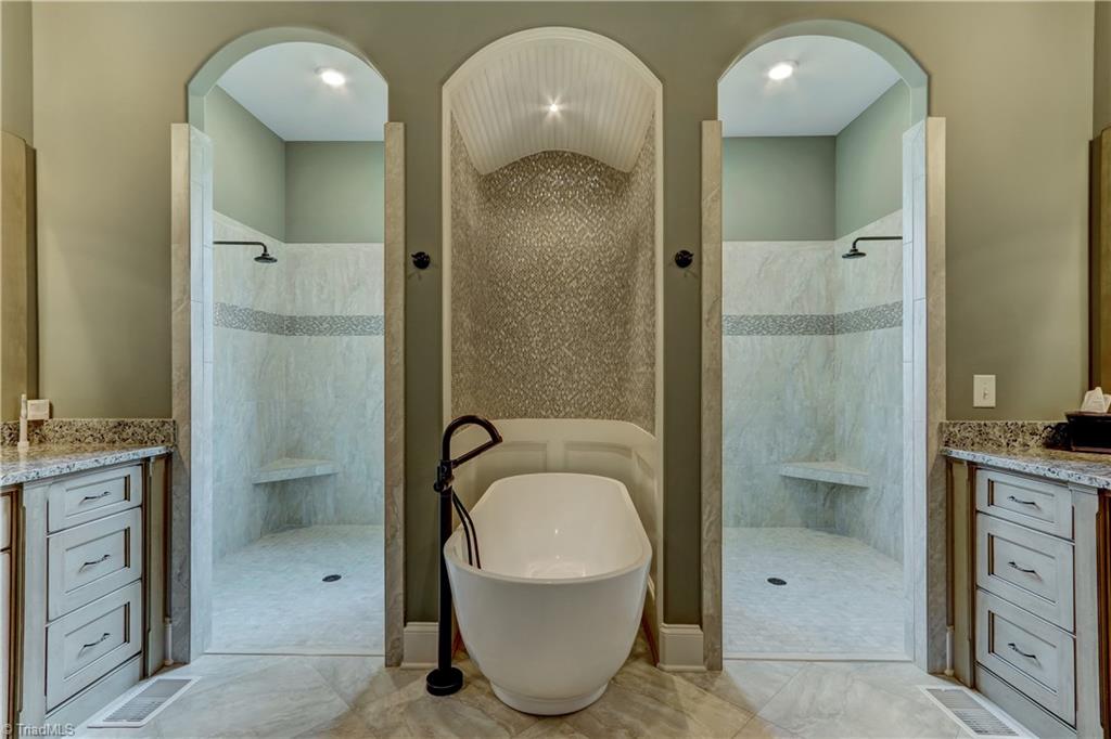 6865 Matzinger Court Oak Ridge, NC 27310 - Photo 13 of 28 This Master Bath is like a trip to the Spa. Large double shower with tile accent that features LED lighting; the Soaking Tub has its own alcove with bead board barrel ceiling, tile and wood accented walls.