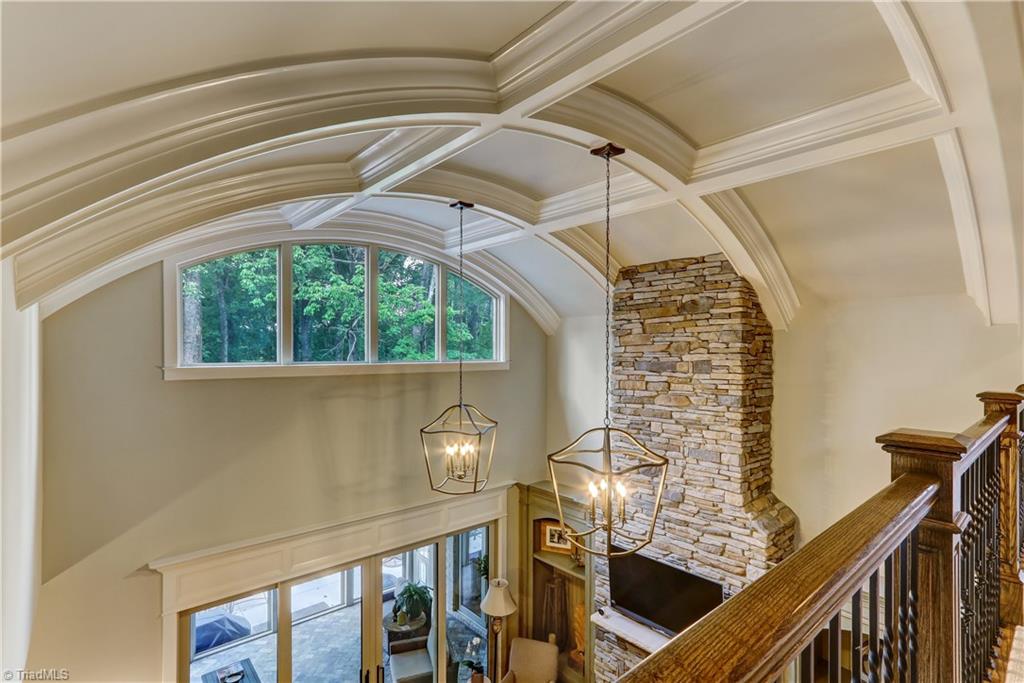 6865 Matzinger Court Oak Ridge, NC 27310 - Photo 6 of 28 Second floor windows accent the barrel ceiling detail providing additional light to the Great Room and great views from the second floor catwalk.