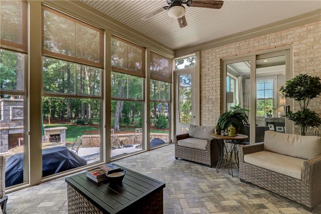 6865 Matzinger Court Oak Ridge, NC 27310 - Photo 7 of 28 This screened porch provides three seasons worth of fun! Easy Breeze window system with shades, bead board ceiling detail, ceiling fan with light, and tile flooring. Easy access to patio and outdoor fireplace.