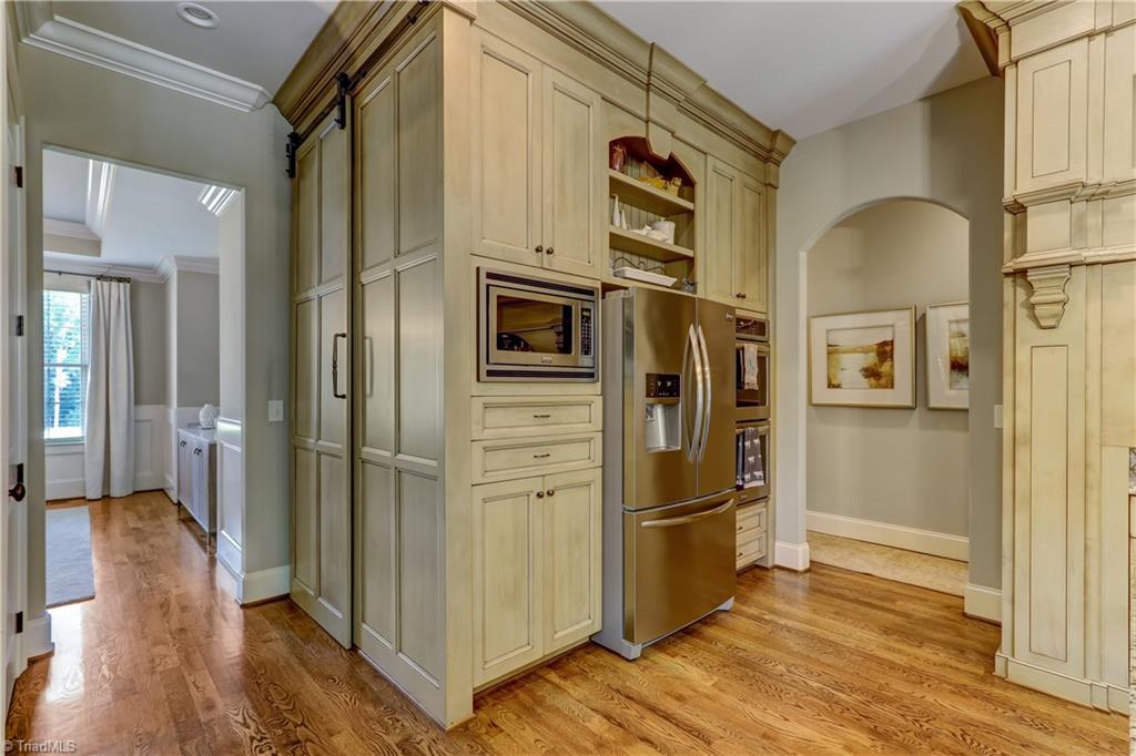 6865 Matzinger Court Oak Ridge, NC 27310 - Photo 9 of 28 Built in Microwave and double wall ovens, Large walk in pantry with sliding door and lots of cabinet and drawer storage.