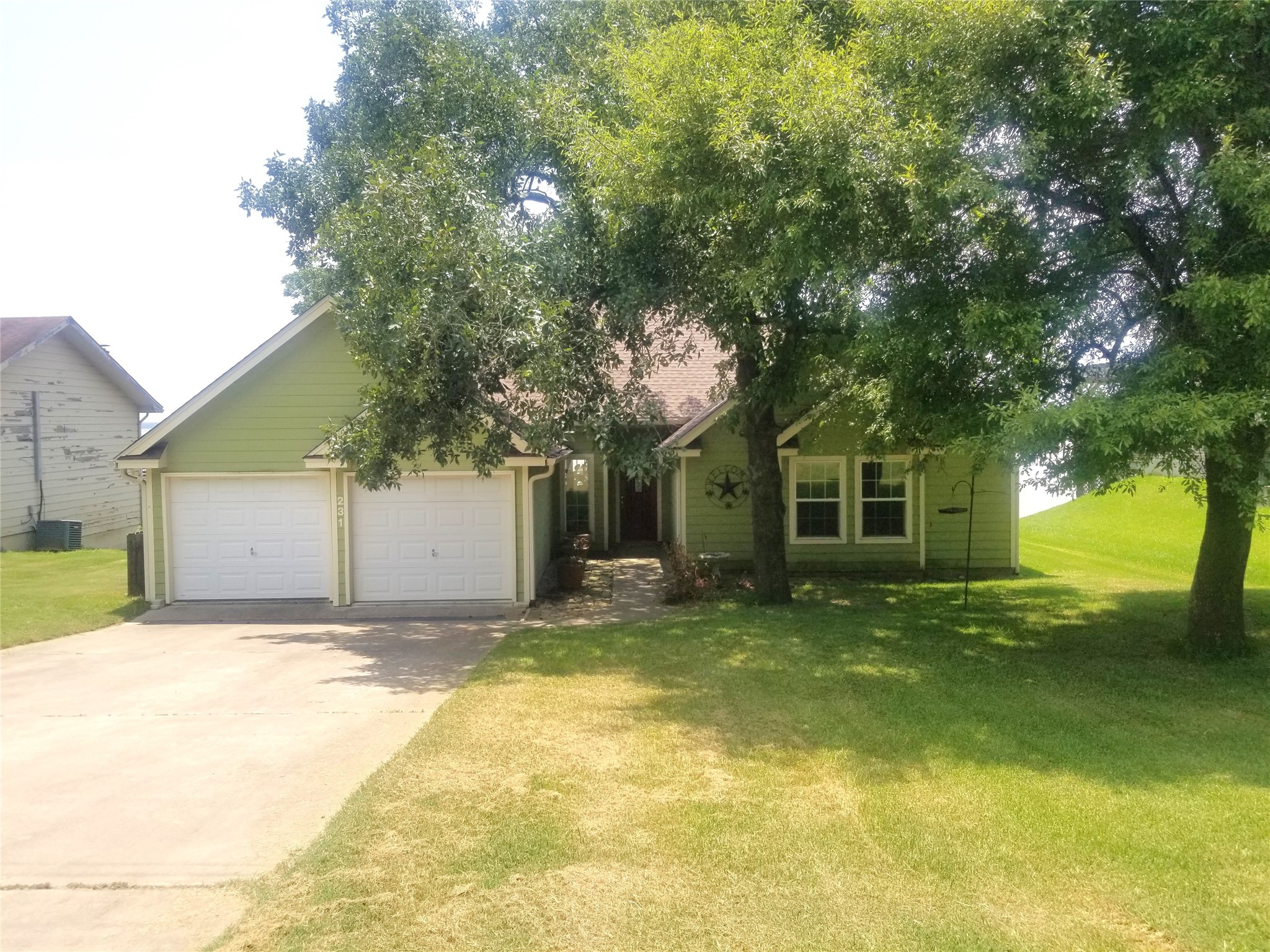 231 Memphis Belle Trinity, TX 75862 - Photo 14 of 47 a view of a house with a yard and large tree