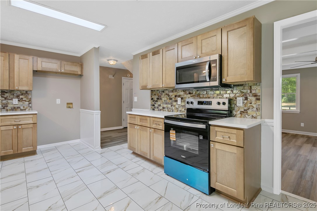 6062 Midus Street Hope Mills, NC 28348 - Photo 13 of 49 a kitchen with stainless steel appliances granite countertop a stove a sink and a refrigerator