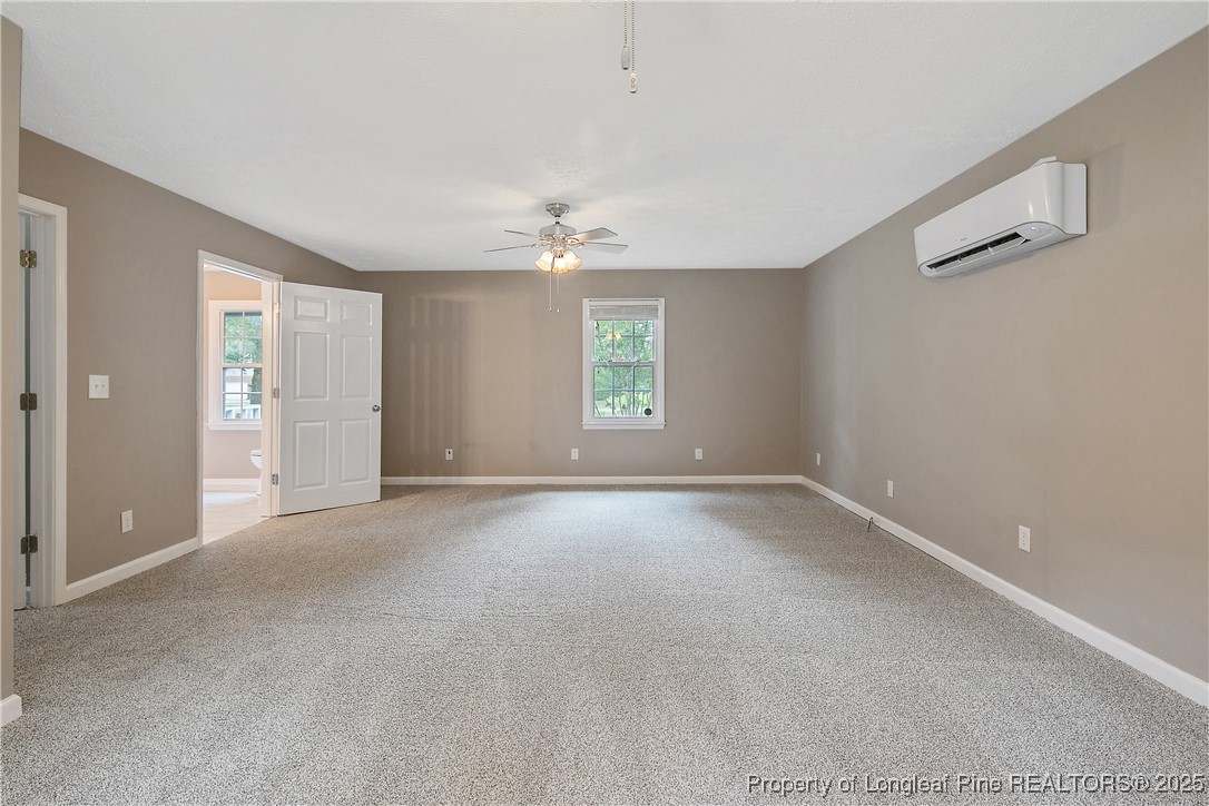 6062 Midus Street Hope Mills, NC 28348 - Photo 16 of 49 an empty room with windows and chandelier fan