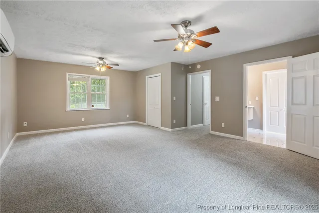 a view of a livingroom with a ceiling fan and window