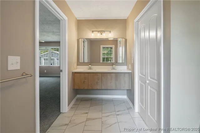a view of kitchen with windows and refrigerator