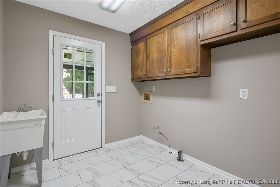 6062 Midus Street Hope Mills, NC 28348 - Photo 22 of 49 a room with a wooden cabinets and a window