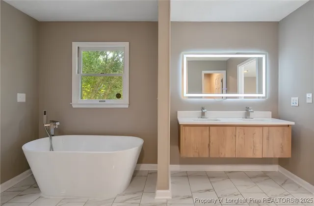 a spacious bathroom with bathtub and window