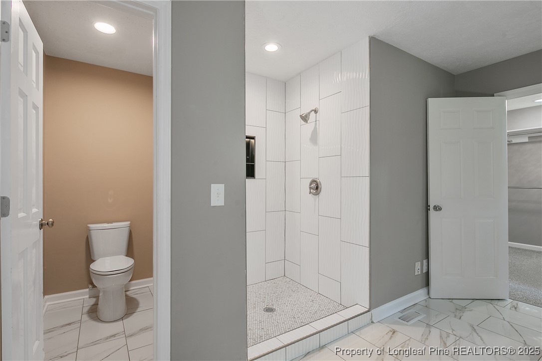 6062 Midus Street Hope Mills, NC 28348 - Photo 29 of 49 a bathroom with a shower toilet and sink