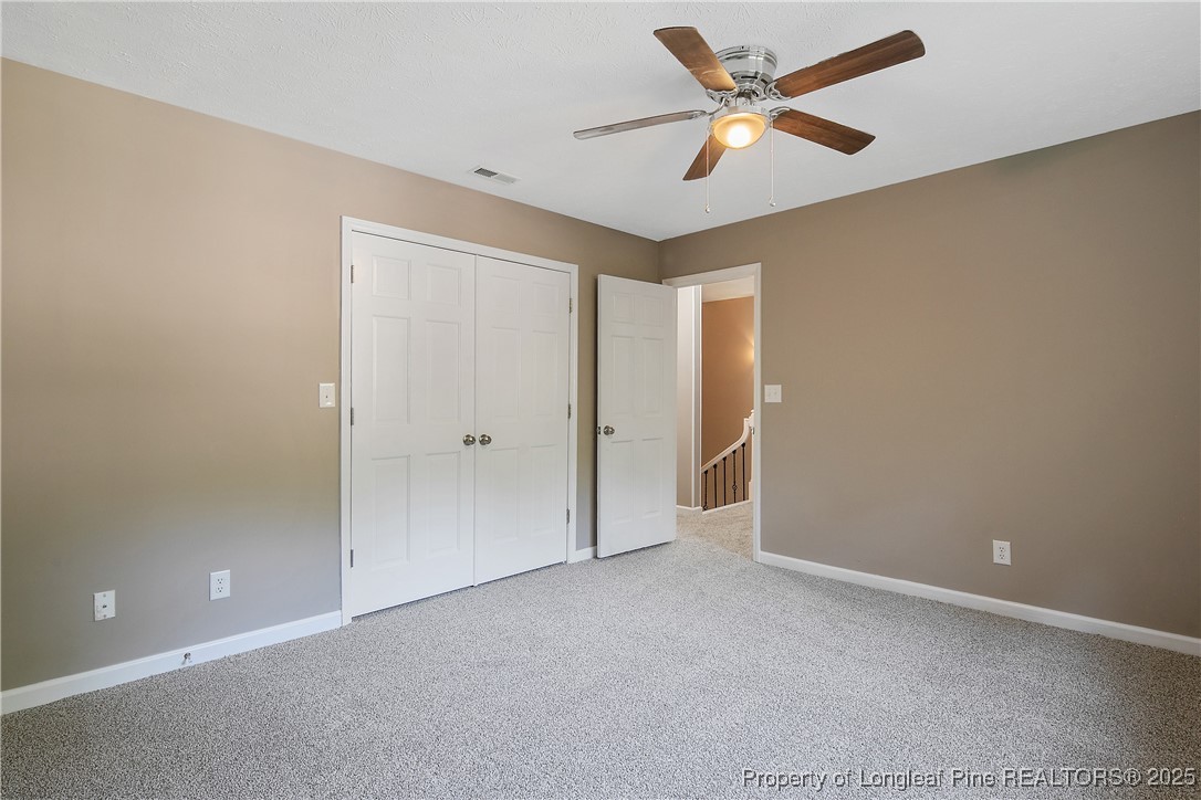 6062 Midus Street Hope Mills, NC 28348 - Photo 32 of 49 an empty room with closet and a ceiling fan