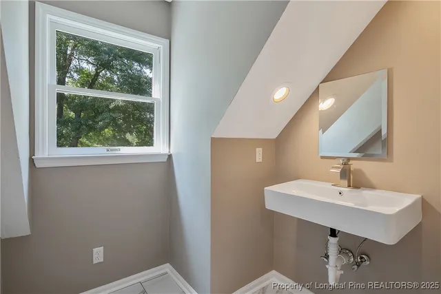a bathroom with a sink a mirror and a window