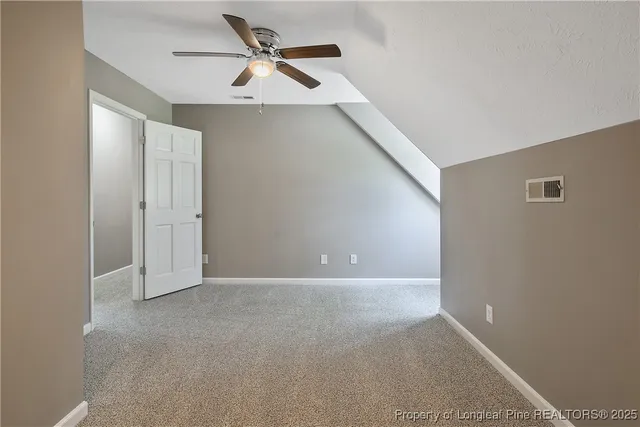 a view of a big room with closet and ceiling fan