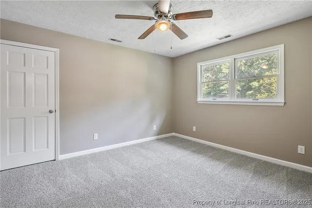 a view of room with window and ceiling fan