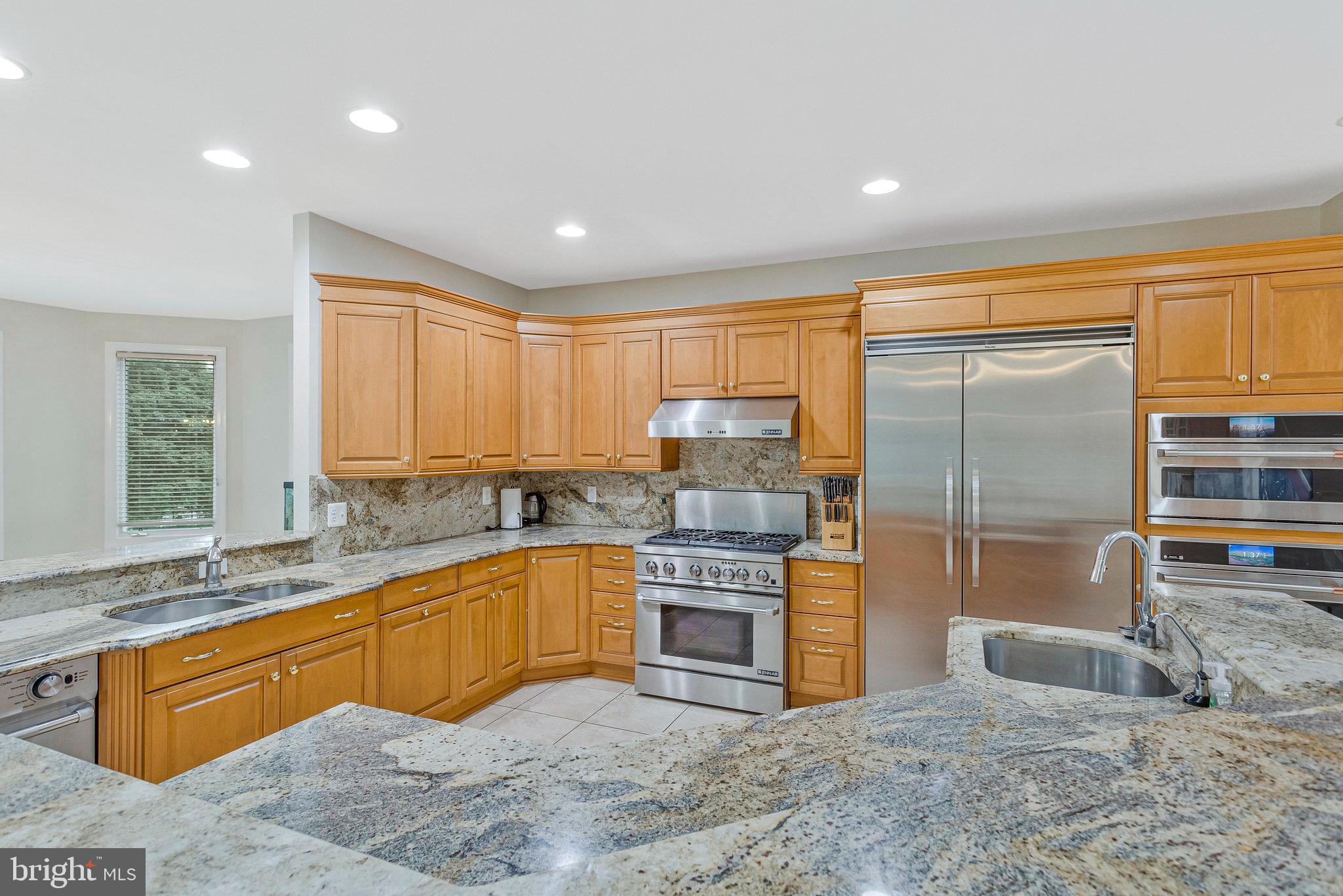 2901 George Howard Way Davidsonville, MD 21035 - Photo 14 of 70 a kitchen with stainless steel appliances granite countertop a sink stove and refrigerator