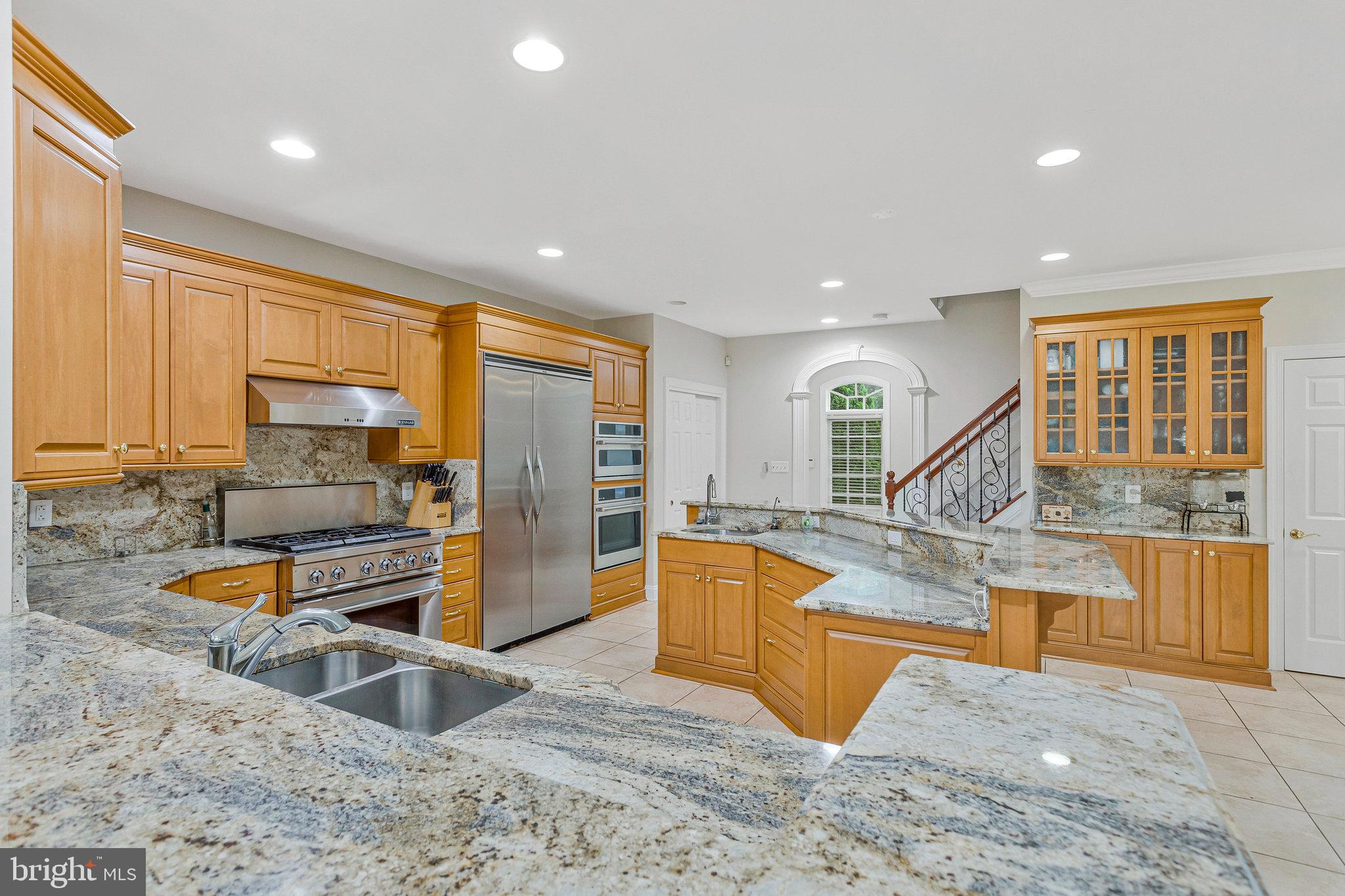 2901 George Howard Way Davidsonville, MD 21035 - Photo 15 of 70 a view of a kitchen with kitchen island granite countertop a large counter top stainless steel appliances and cabinets