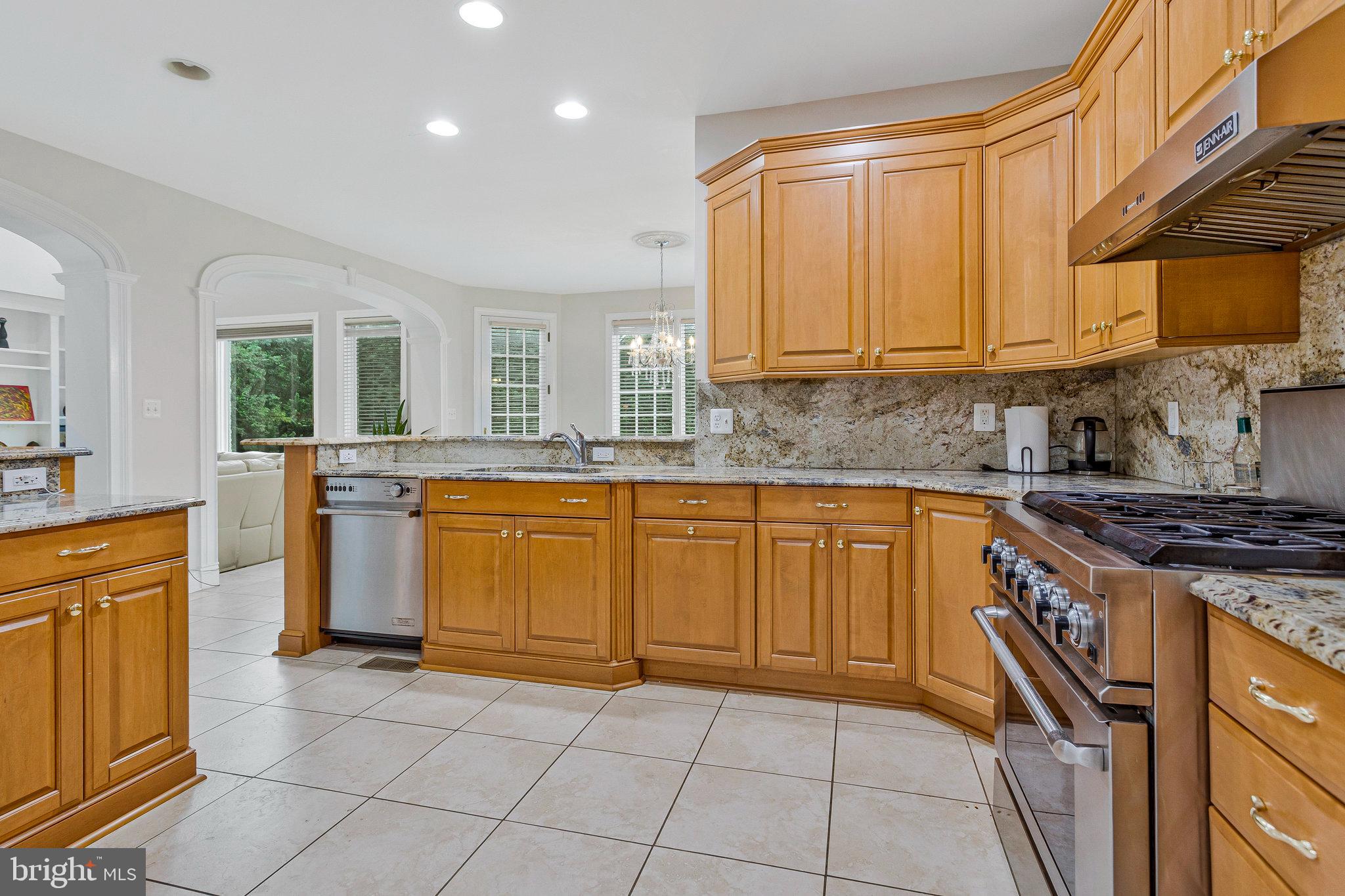 2901 George Howard Way Davidsonville, MD 21035 - Photo 18 of 70 a kitchen with a sink a stove top oven and cabinets