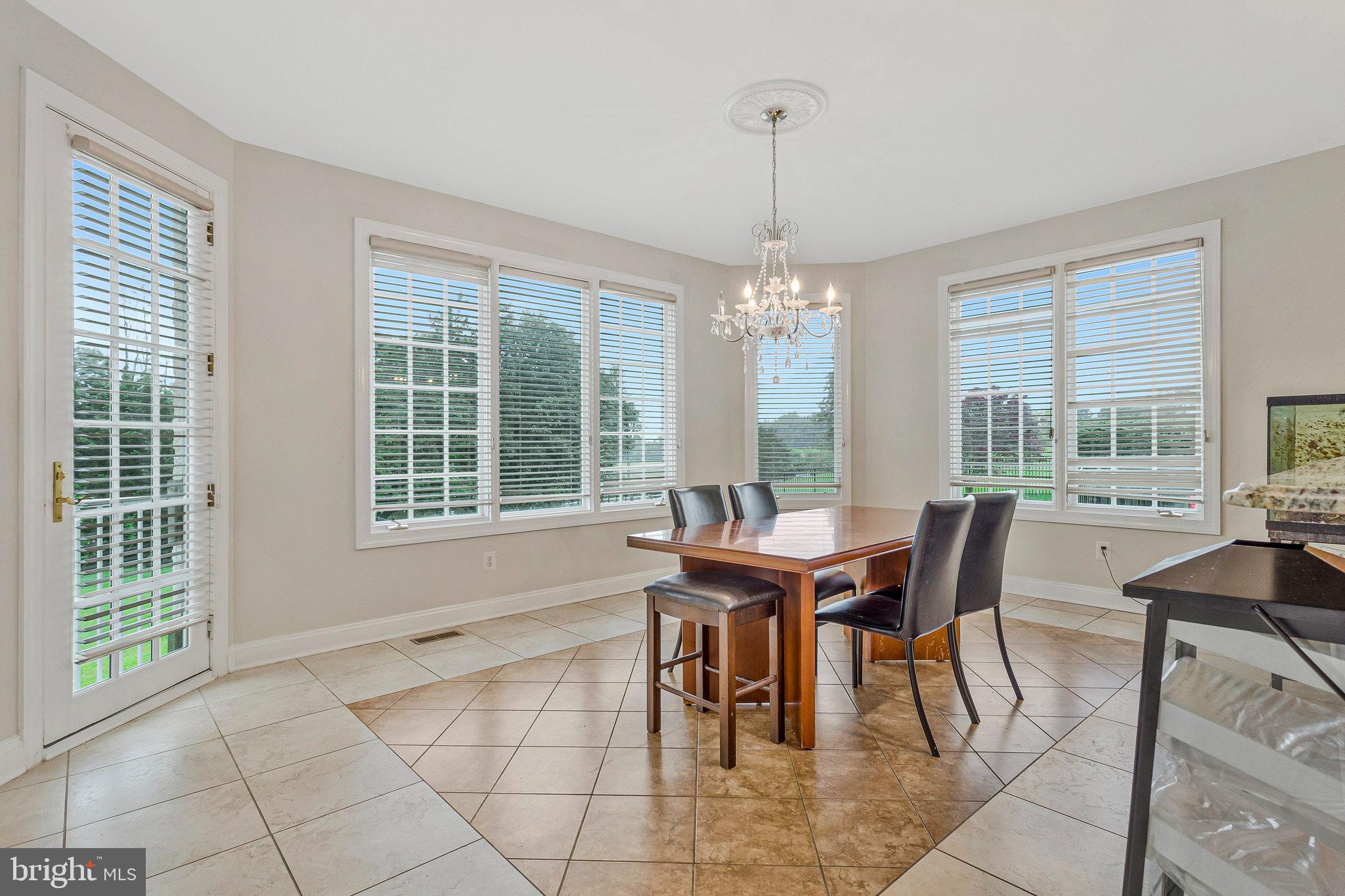 2901 George Howard Way Davidsonville, MD 21035 - Photo 20 of 70 a dining room with furniture a chandelier and wooden floor