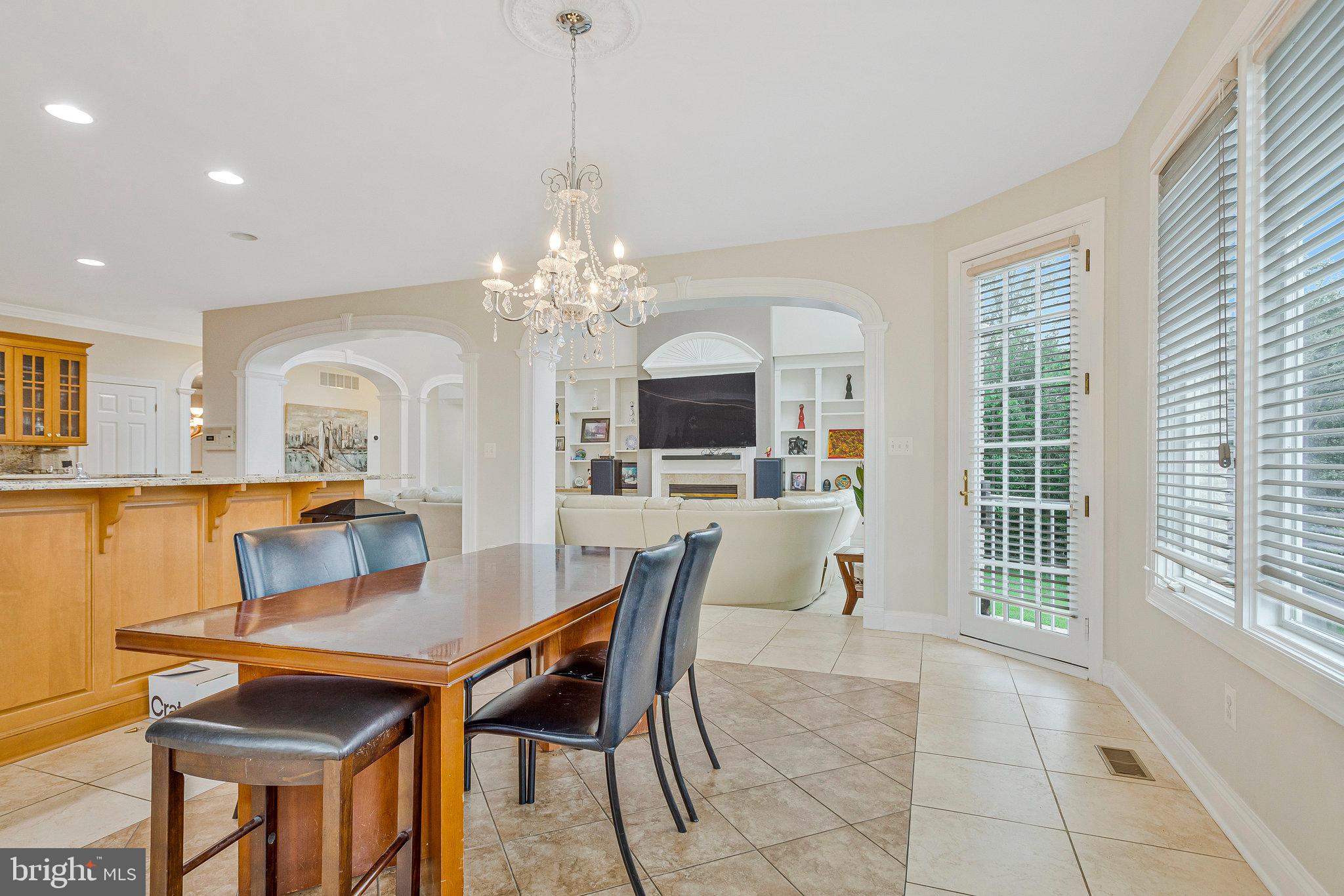 2901 George Howard Way Davidsonville, MD 21035 - Photo 21 of 70 a view of a dining room with furniture and a chandelier