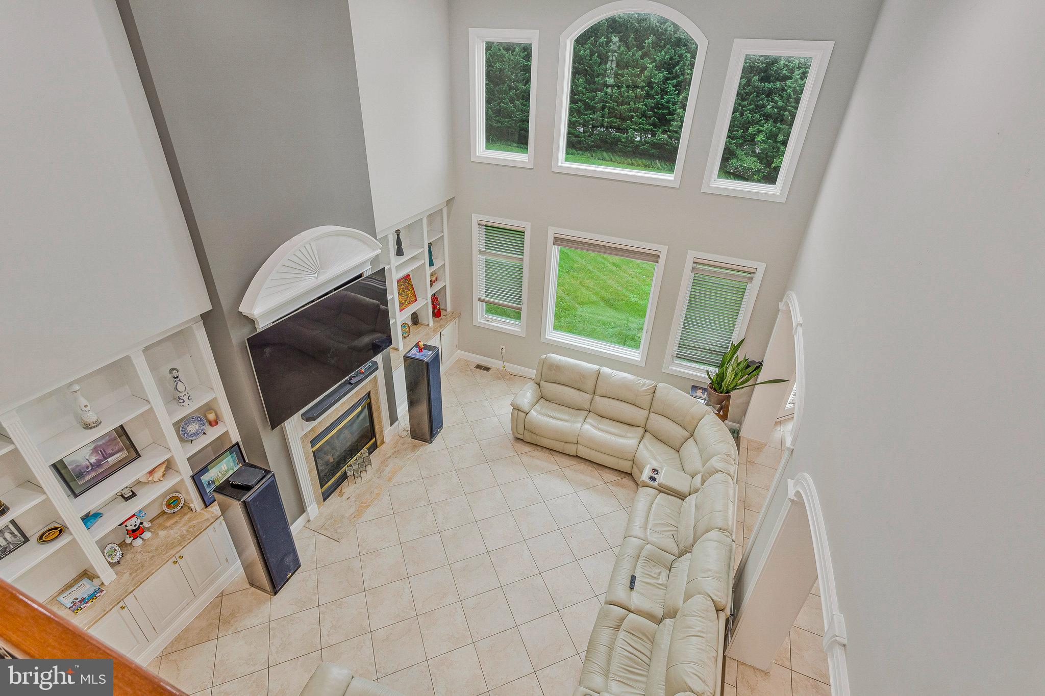 2901 George Howard Way Davidsonville, MD 21035 - Photo 30 of 70 a living room with furniture a fireplace and a flat tv screen