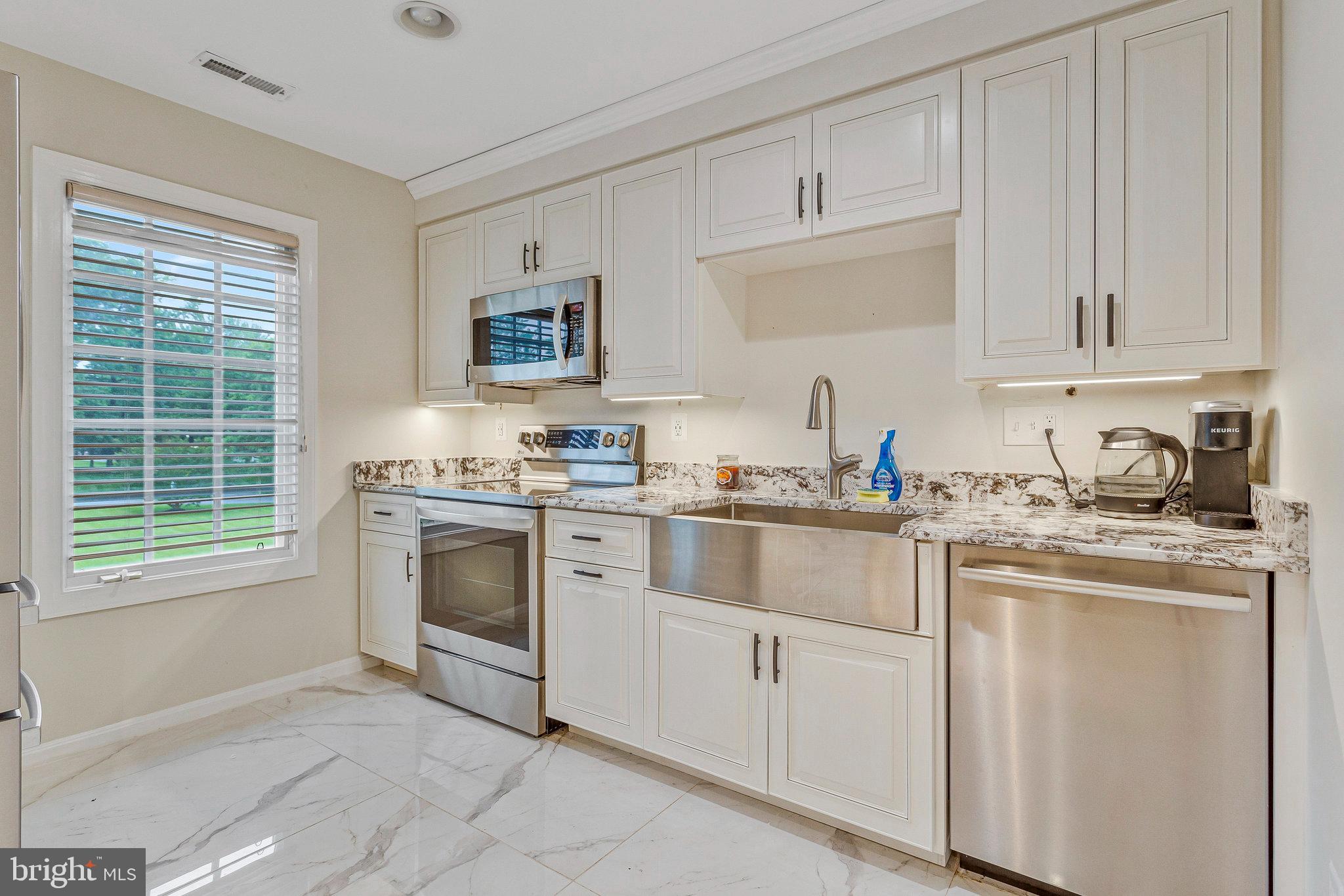 2901 George Howard Way Davidsonville, MD 21035 - Photo 41 of 70 a kitchen with granite countertop white cabinets and white appliances