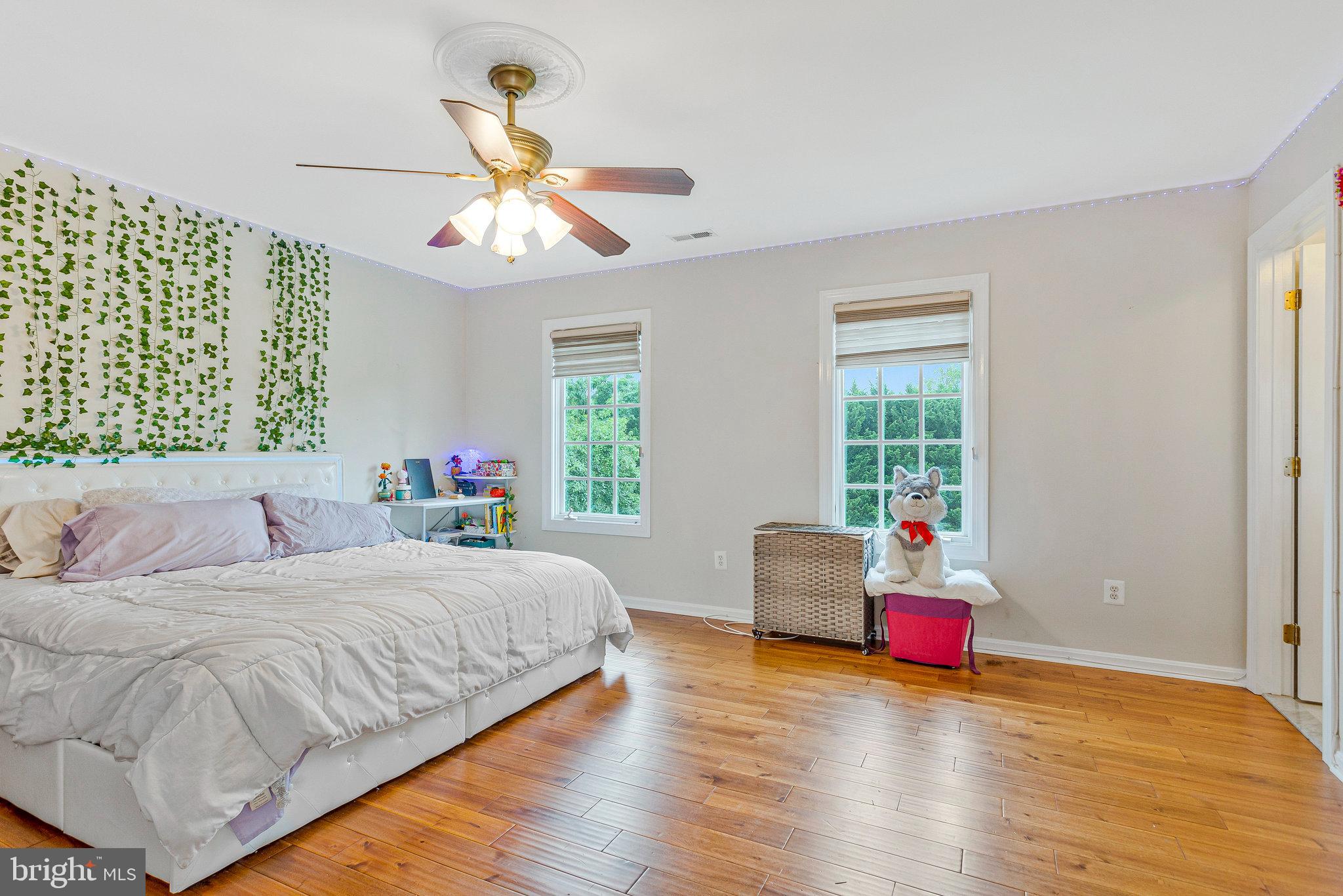 2901 George Howard Way Davidsonville, MD 21035 - Photo 49 of 70 a bedroom with a bed and a chandelier