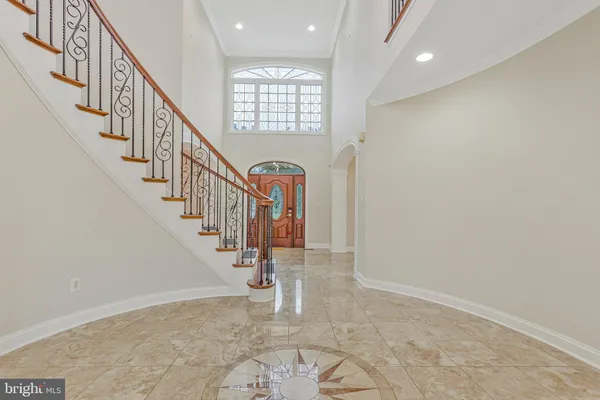 a dining room with furniture a chandelier and wooden floor
