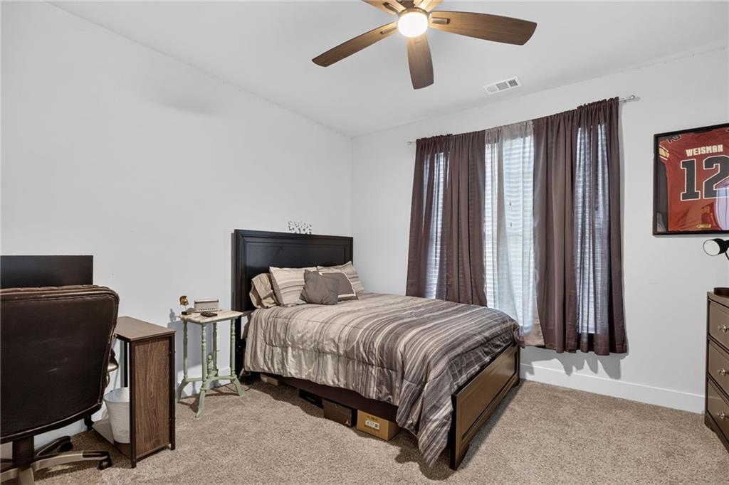 139 Manchester Lane Villa Rica, GA 30180 - Photo 25 of 60 a bedroom with a bed and a chandelier