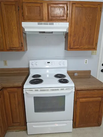 a stove top oven sitting inside of a kitchen