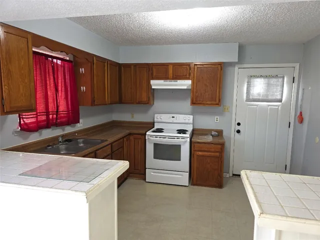 a kitchen with a stove and a refrigerator