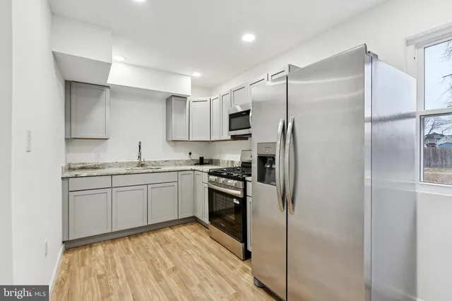 a kitchen with a refrigerator and a sink