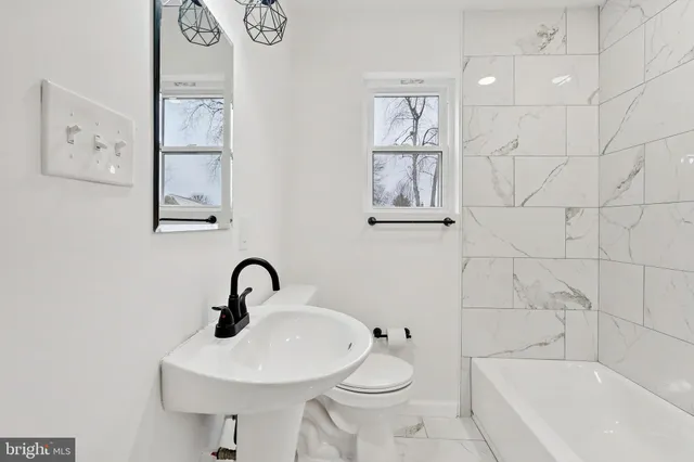 a bathroom with a sink toilet and bathtub