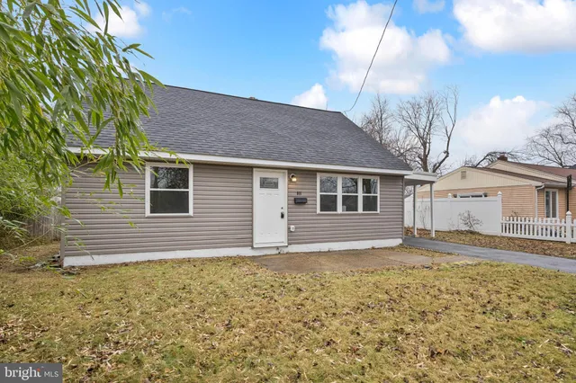 a house that has a large tree in front of it
