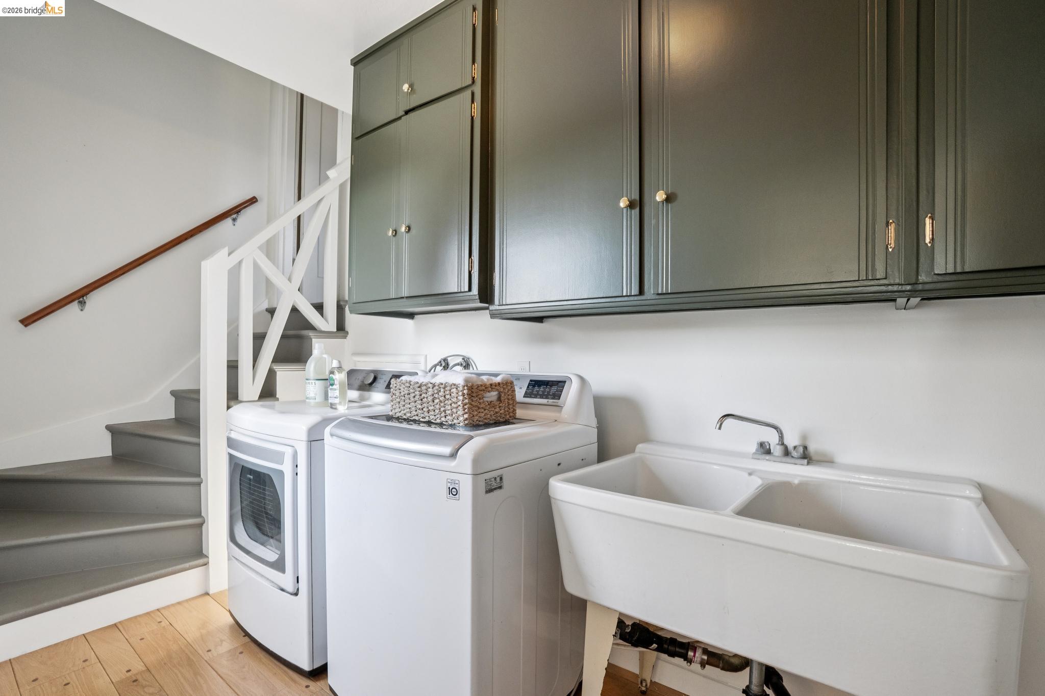 38 Highgate Road Kensington, CA 94707 - Photo 65 of 78 Built-in overhead cabinetry, divided utility sink, and wood-finish flooring