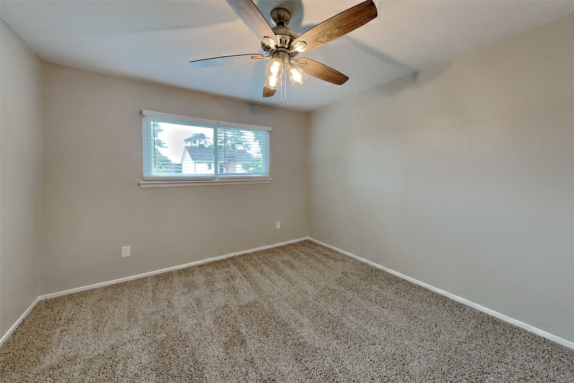 10015 Rippling Fields Drive Houston, TX 77064 - Photo 16 of 24 an empty room with windows and fan