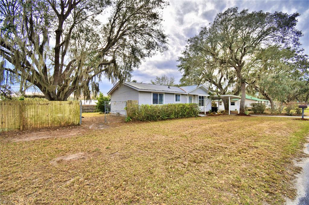 337 Swingle Street Frostproof, FL 33843 - Photo 1 of 1 a front view of a house with a yard and trees