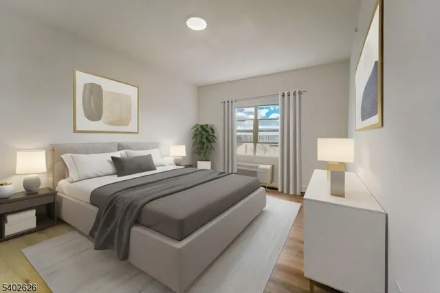 a bedroom with a bed and a large window