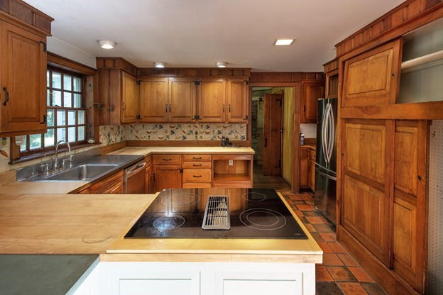 69 Fox Farms Road Northampton, MA 01062 - Photo 9 of 38 a kitchen with kitchen island granite countertop a sink and wooden cabinets