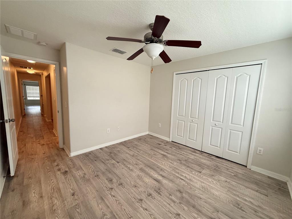 9854 Trumpet Vine Loop, Unit 9854 Trinity, FL 34655 - Photo 11 of 19 a view of empty room with wooden floor