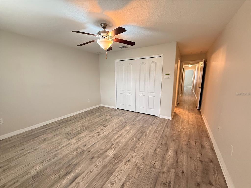 9854 Trumpet Vine Loop, Unit 9854 Trinity, FL 34655 - Photo 15 of 19 a view of an empty room with wooden floor