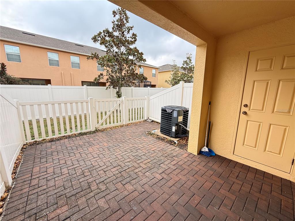 9854 Trumpet Vine Loop, Unit 9854 Trinity, FL 34655 - Photo 19 of 19 a view of a porch with wooden floor and fence