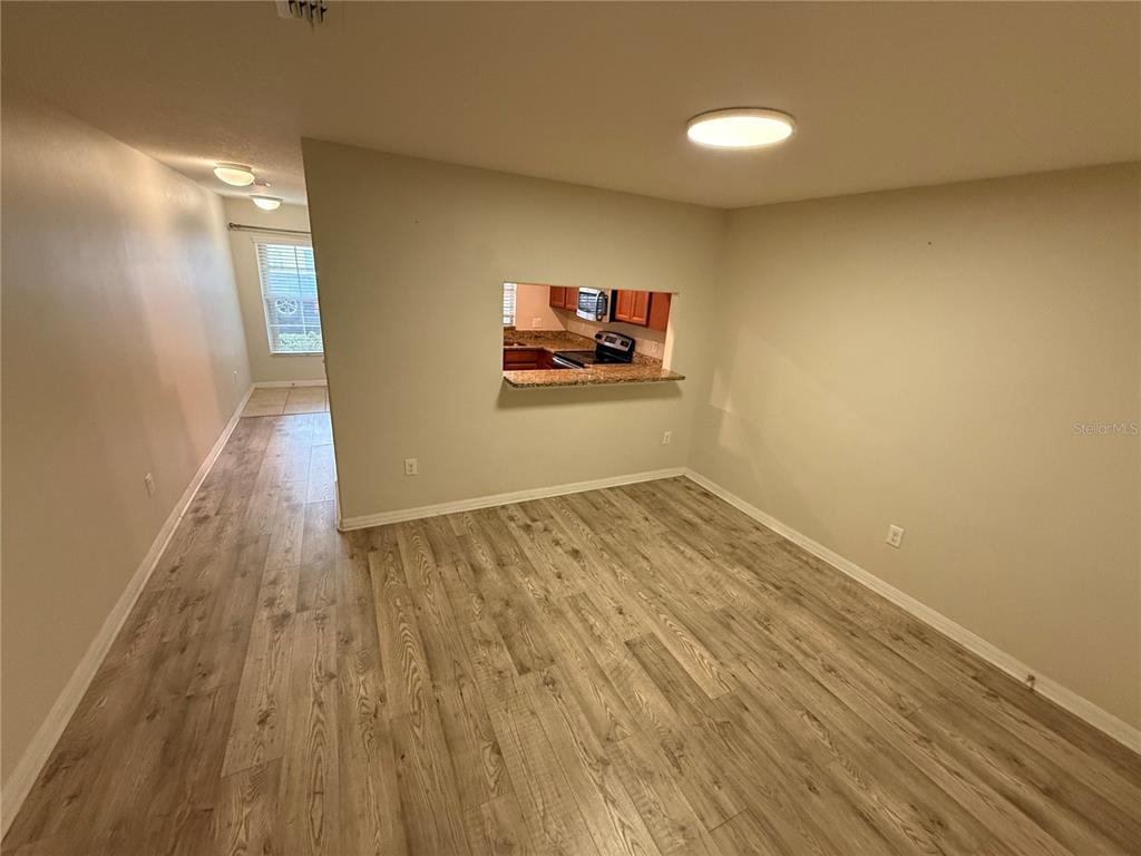 9854 Trumpet Vine Loop, Unit 9854 Trinity, FL 34655 - Photo 6 of 19 a view of room with wooden floor