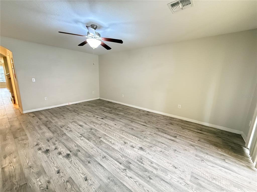 9854 Trumpet Vine Loop, Unit 9854 Trinity, FL 34655 - Photo 7 of 19 wooden floor in an empty room