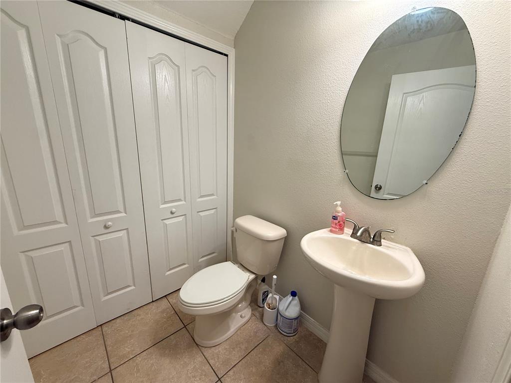 9854 Trumpet Vine Loop, Unit 9854 Trinity, FL 34655 - Photo 8 of 19 a bathroom with a sink toilet and a mirror