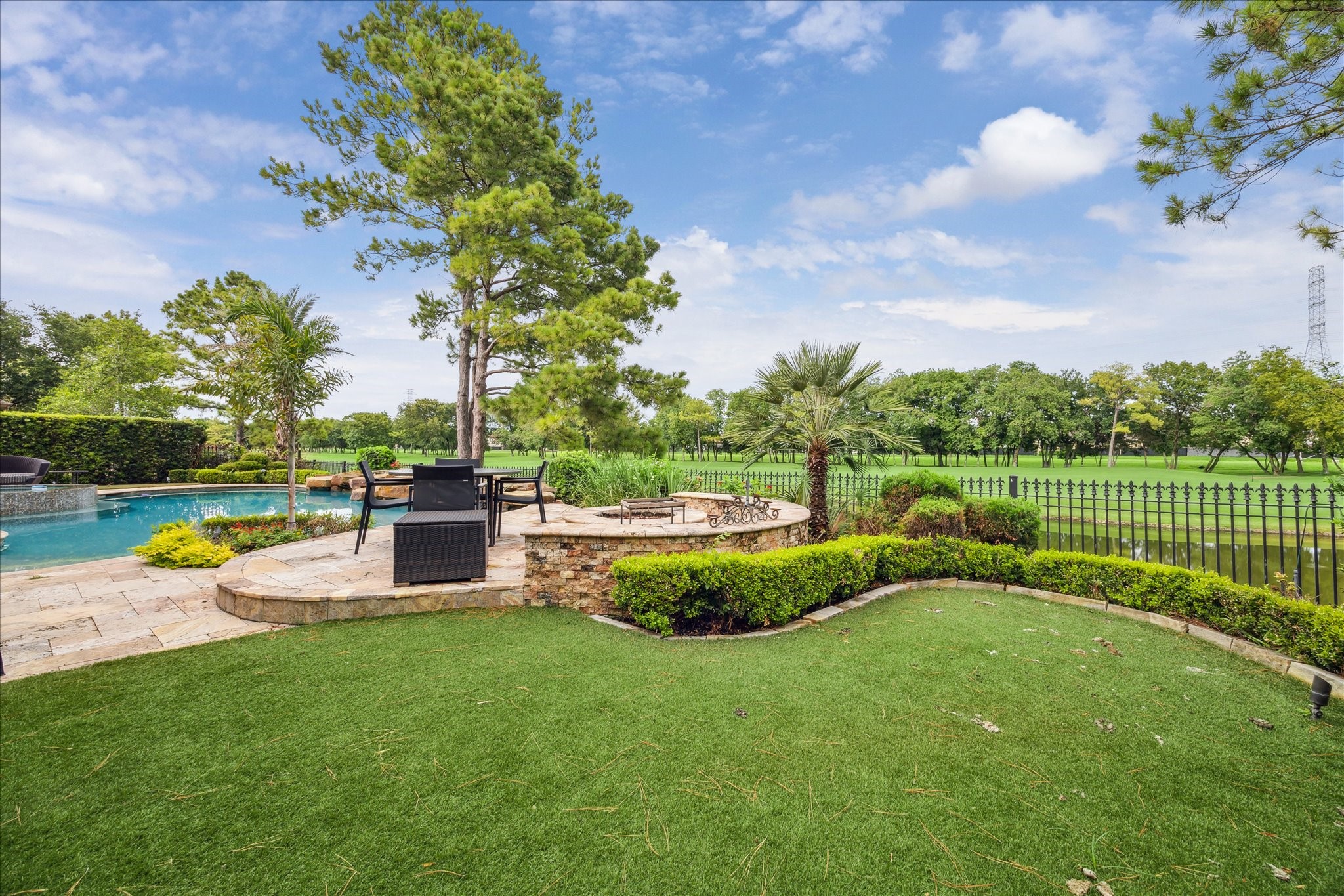 3319 Bridgeberry Lane Houston, TX 77082 - Photo 41 of 50 Raised seating area, fire pit, turf and a fantastic view of the 4th fairway and lake.