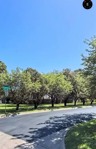 a view of a yard with a tree