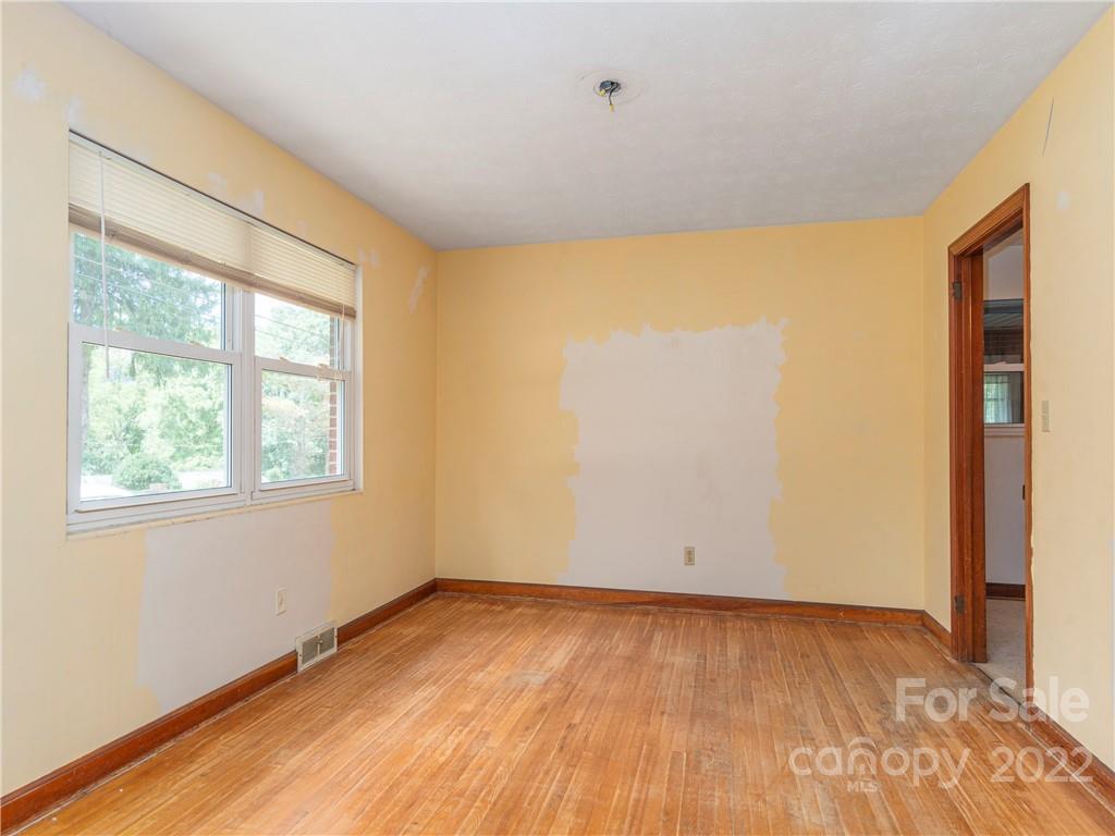764 North Canton Road Canton, NC 28716 - Photo 5 of 16 an empty room with wooden floor and windows