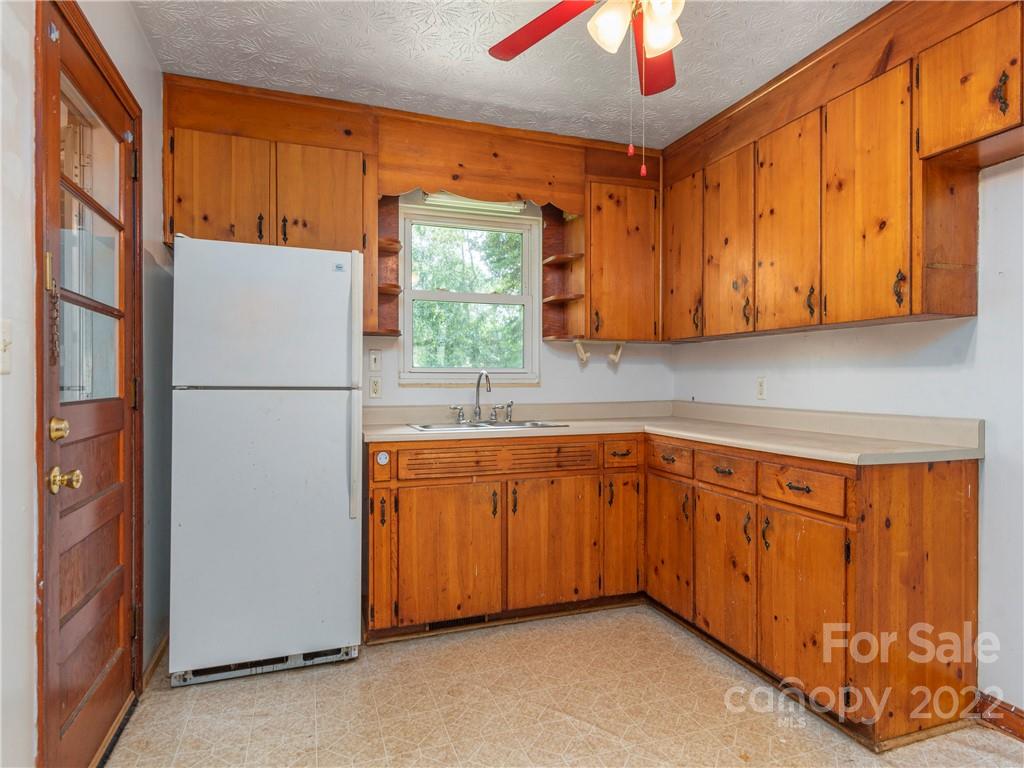 764 North Canton Road Canton, NC 28716 - Photo 6 of 16 a kitchen with stainless steel appliances granite countertop a refrigerator and a sink