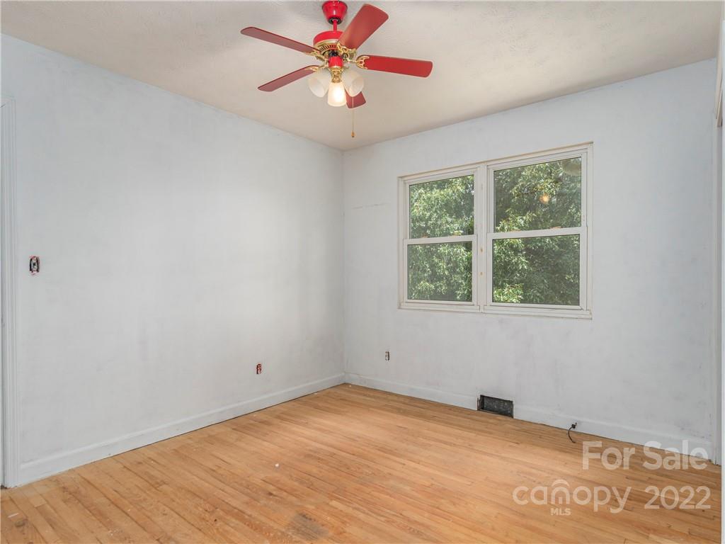 764 North Canton Road Canton, NC 28716 - Photo 8 of 16 an empty room with a window and a fan